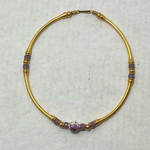 Gold tone circular necklace with painted wood accents